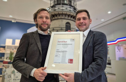 Das Zertifikat für das Qualitätssiegel der "i-Marke" wird übergeben.